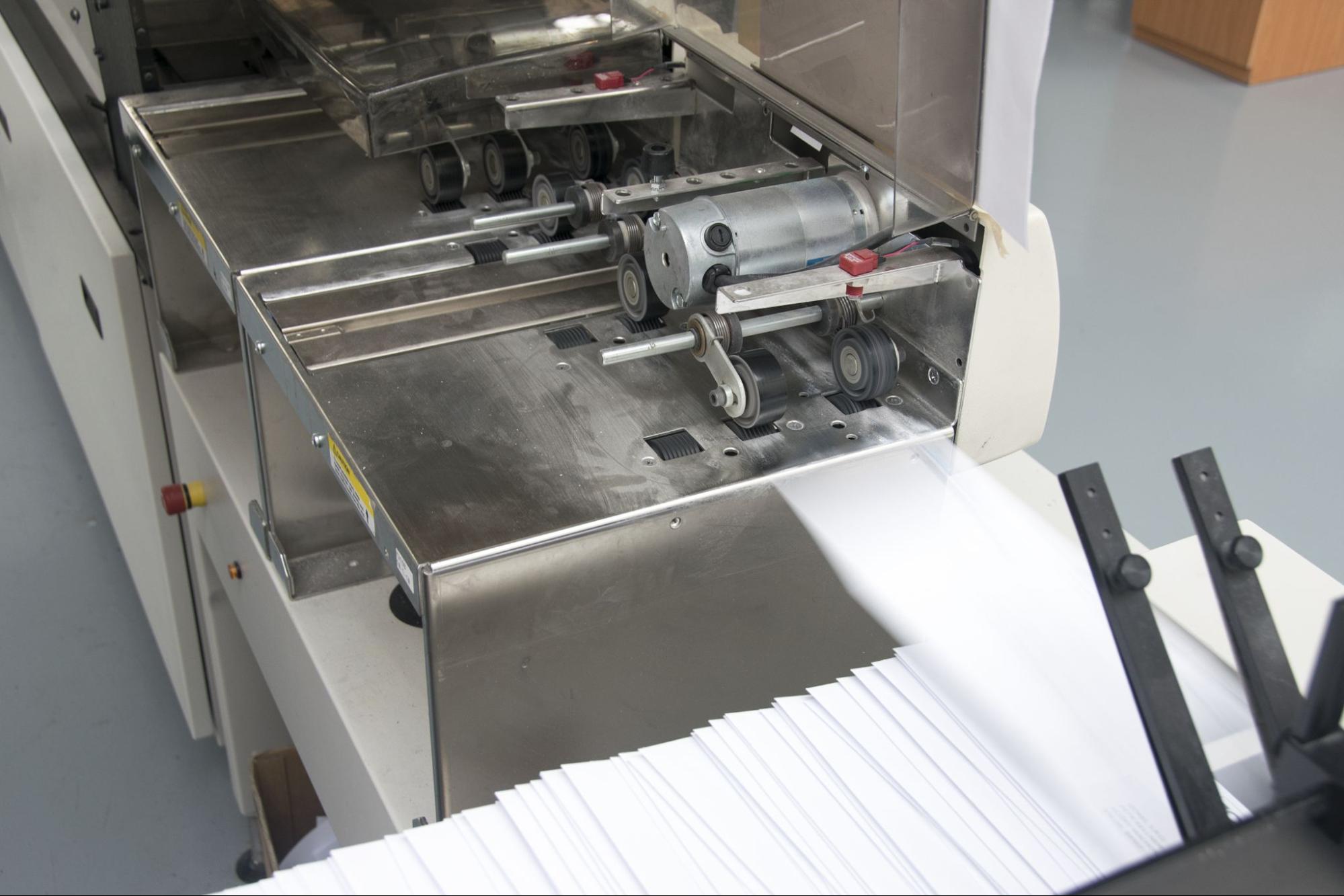 automated paper folding machine processing a stack